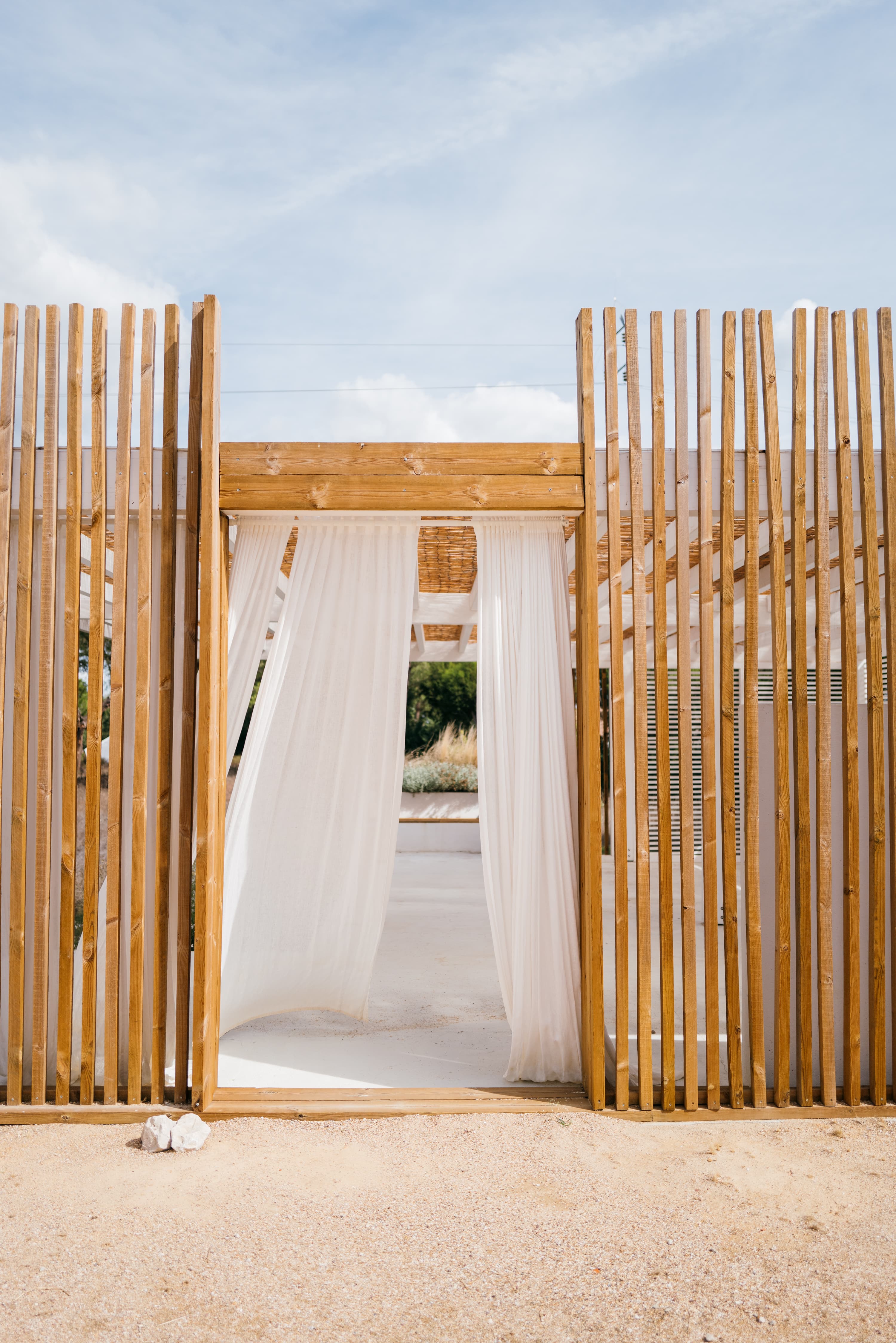 Pergola entrance with flowing white drapes